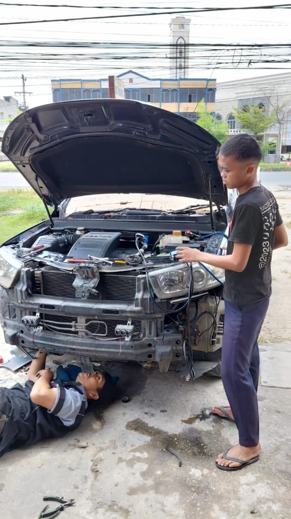 Teknisi melakukan penggantian oli kompresor dan silica